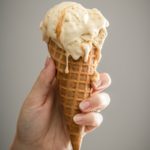 white ice cream on brown cone