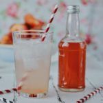 clear glass bottle with orange liquid