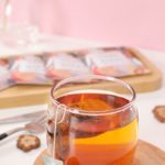 clear drinking glass with orange liquid