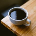 white coffee cup on brown wooden table