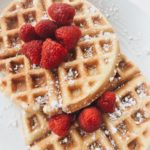 red strawberries on brown waffles